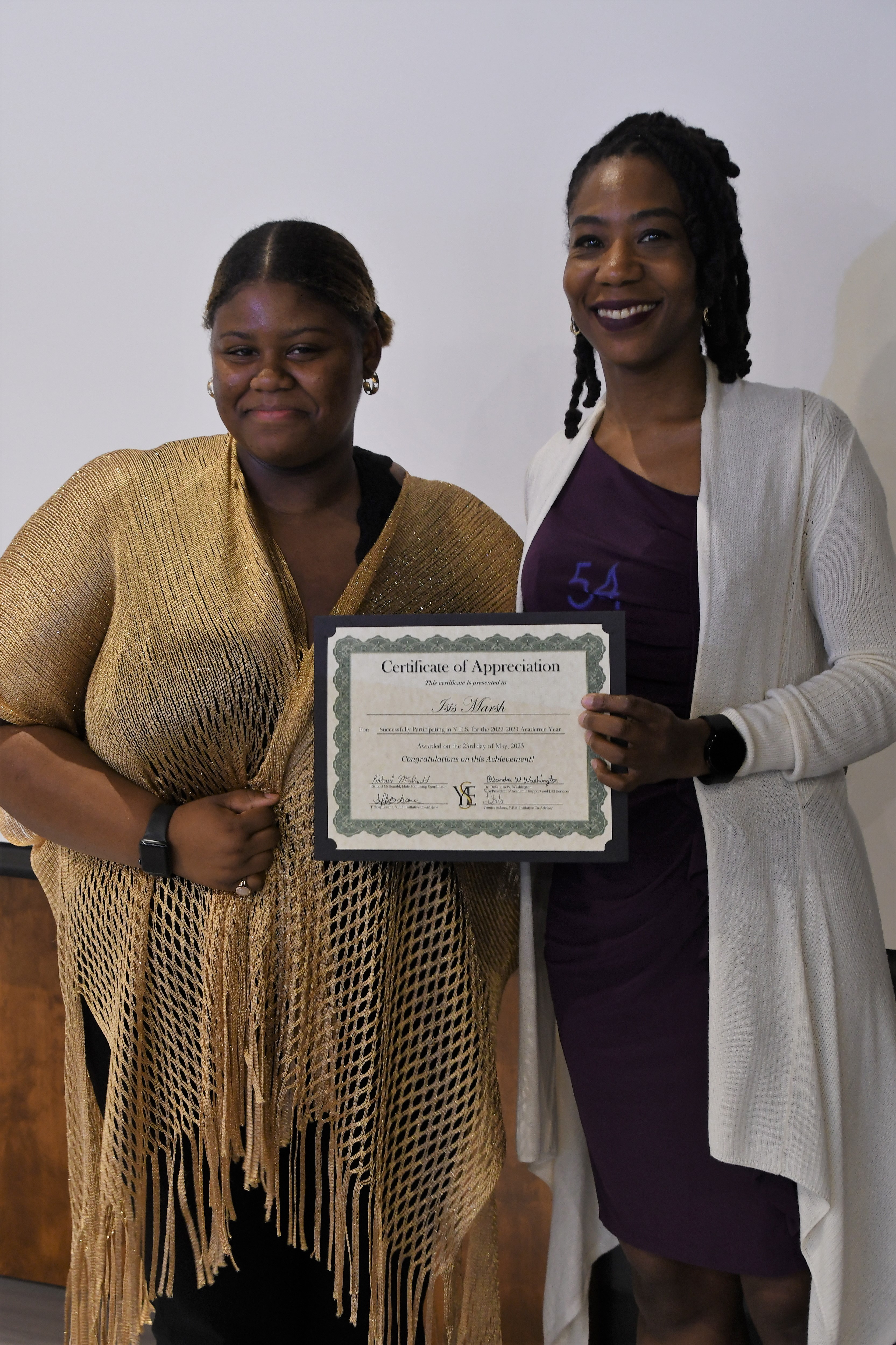 A student receives her Certificate of Appreciate for participating in the YES Initiative.