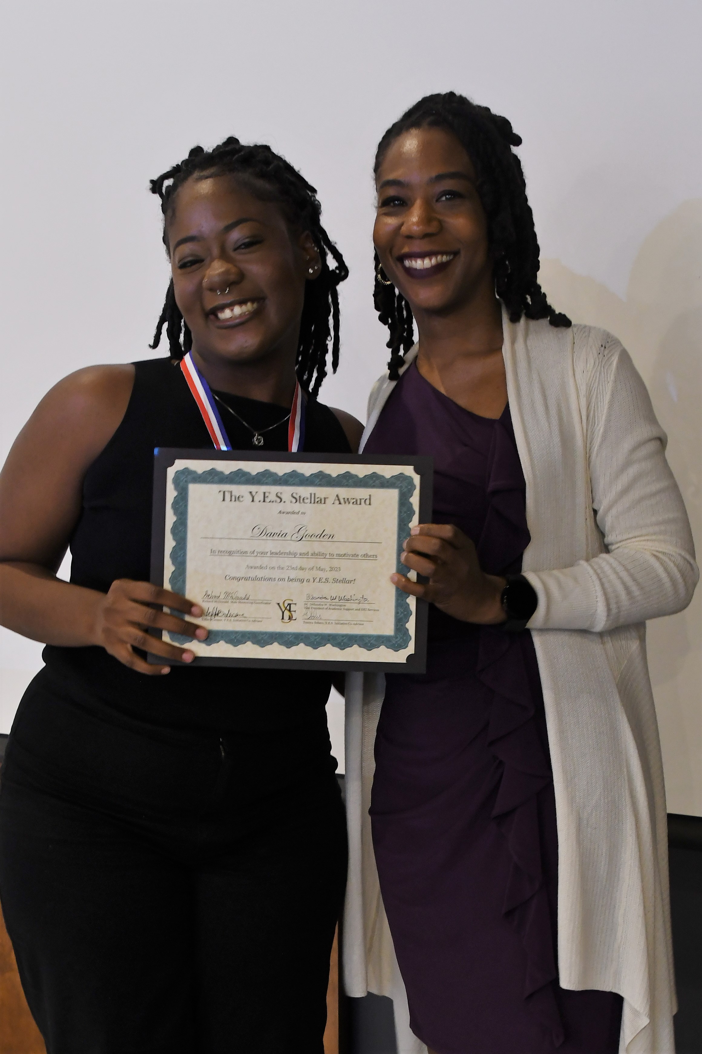 A student receives a YES Stellar Award.