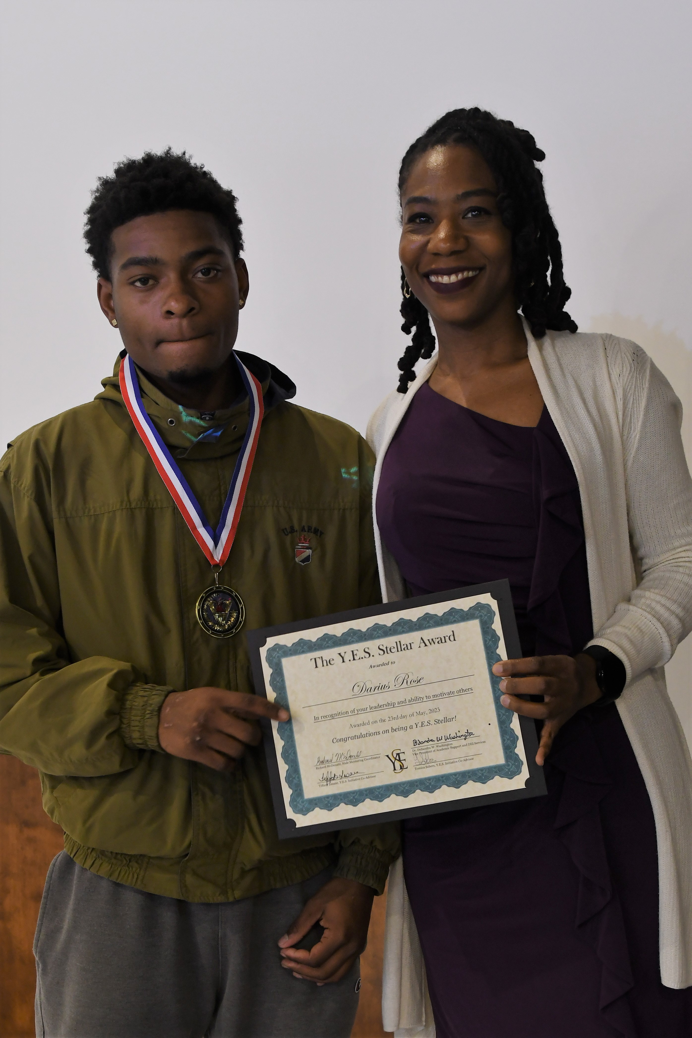 A student receives a YES Stellar Award.