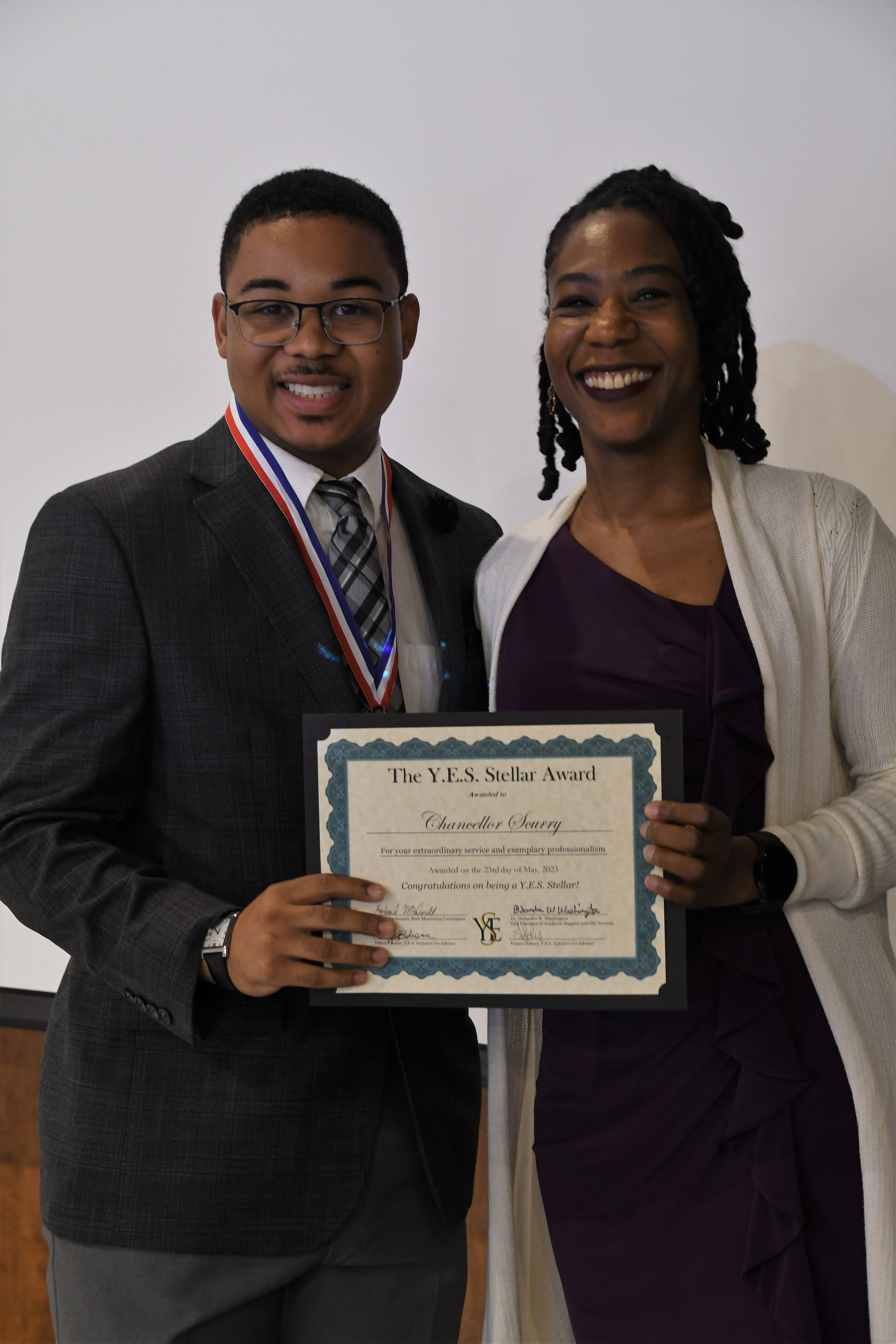 A student receives a YES Stellar Award.