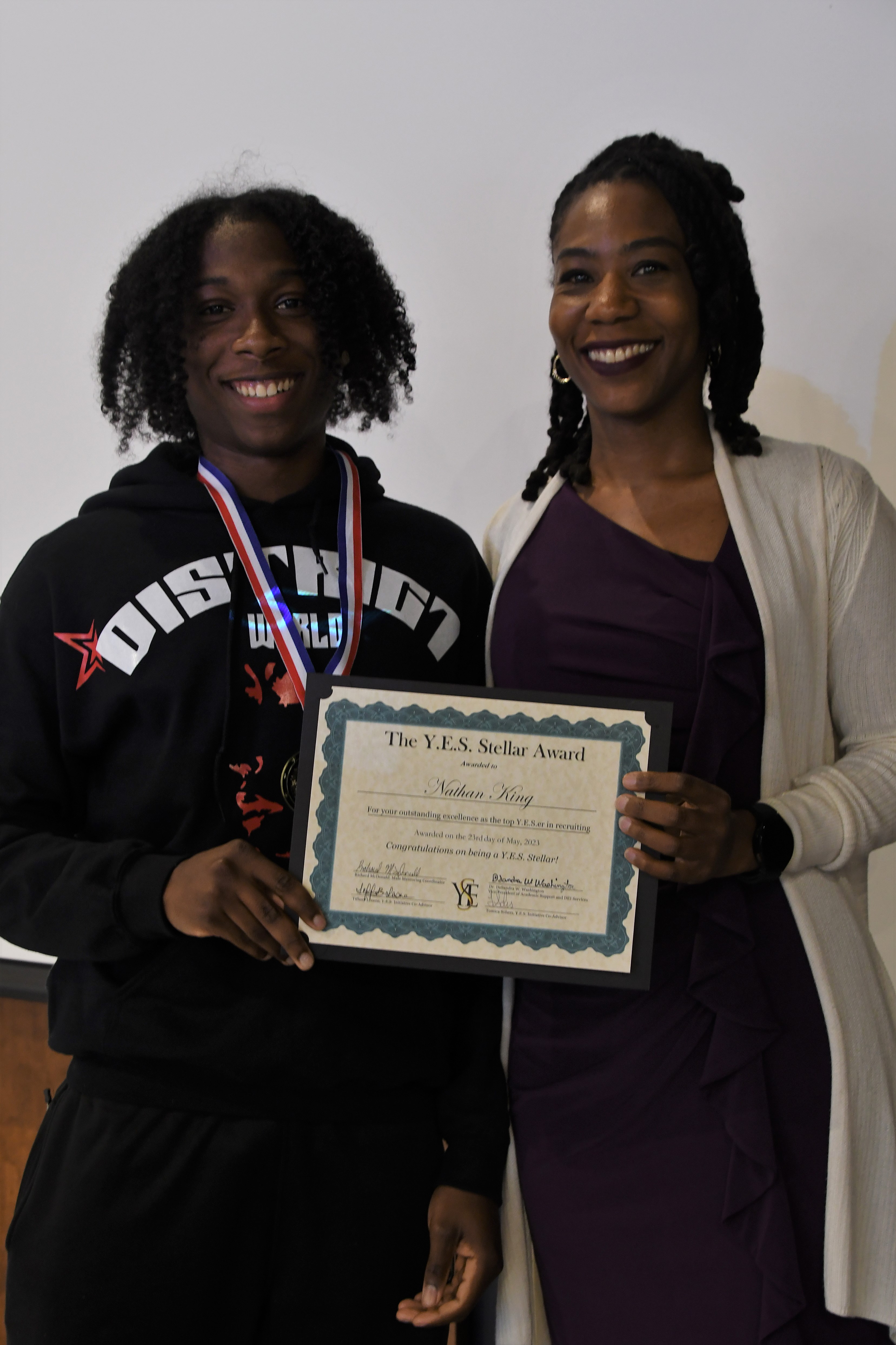 A student receives a YES Stellar Award.