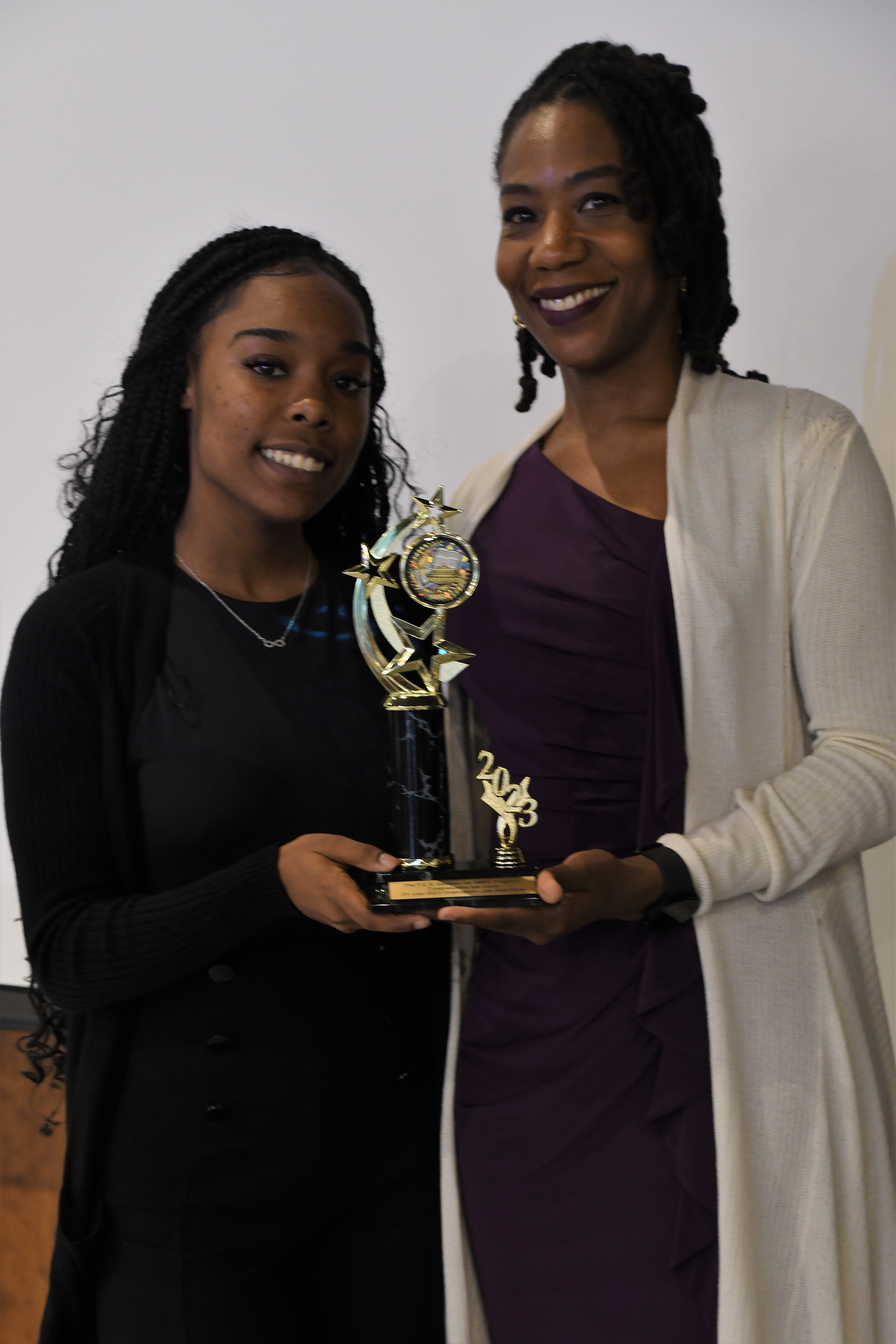 A student receives a trophy of special recognition.