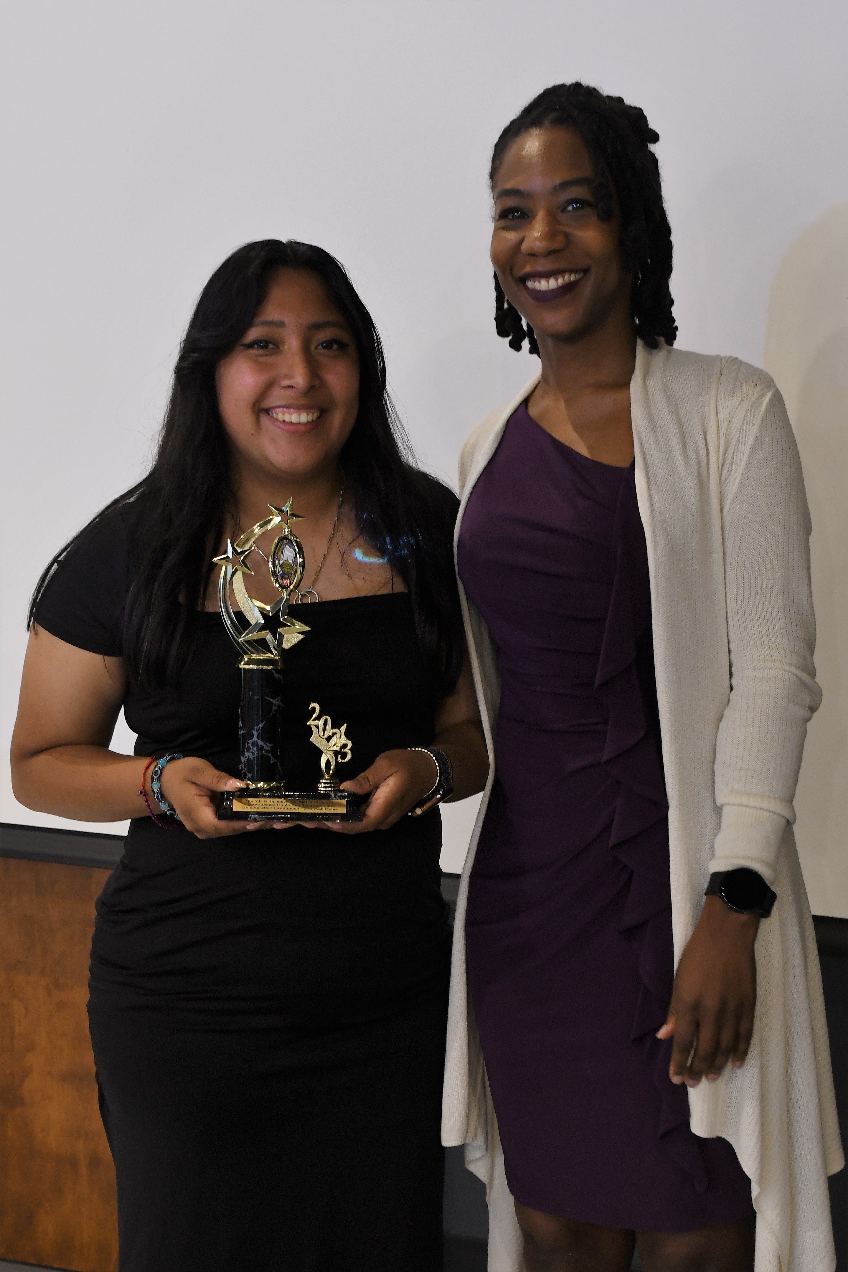 A student receives a trophy of special recognition.