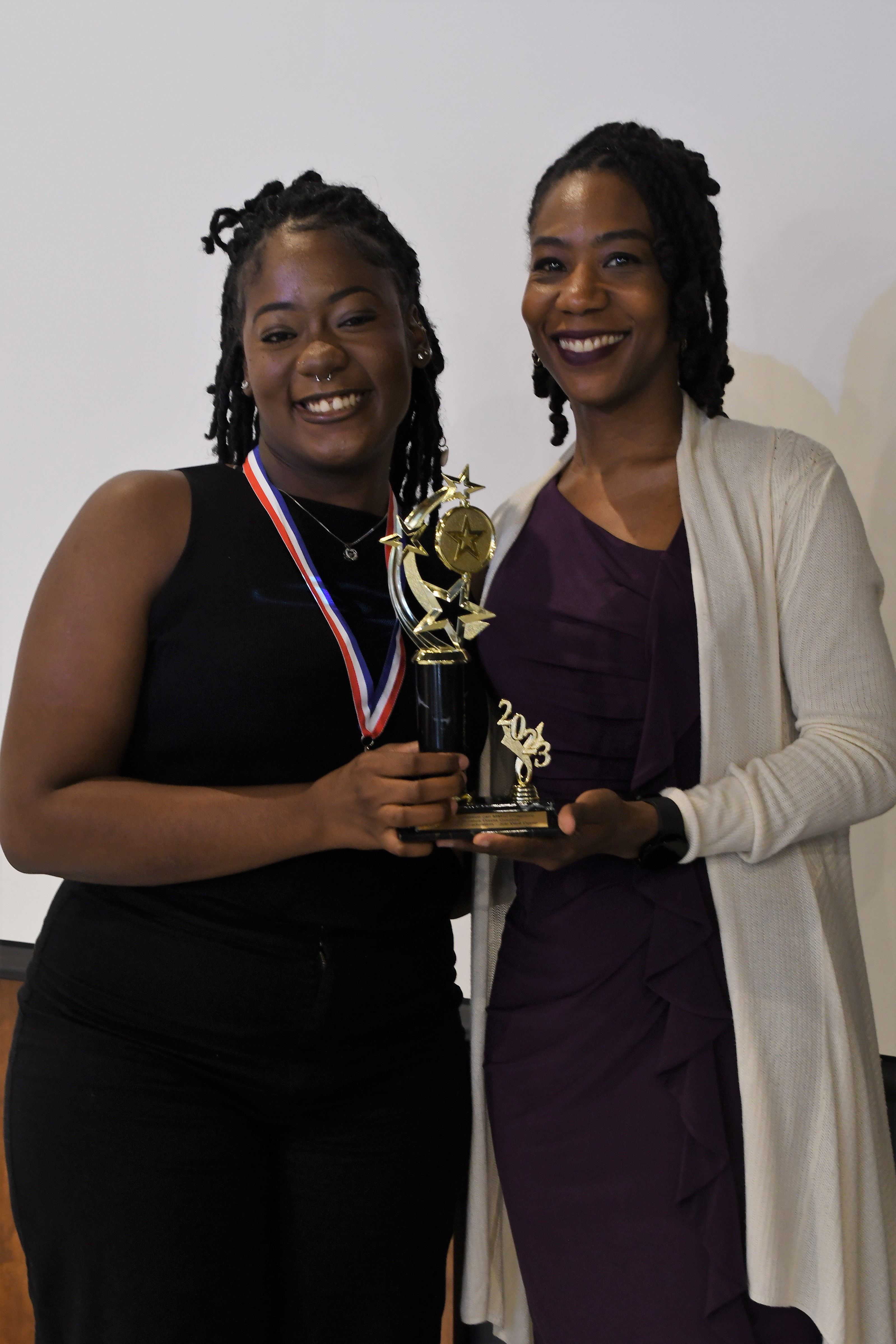 A student receives a trophy of special recognition.