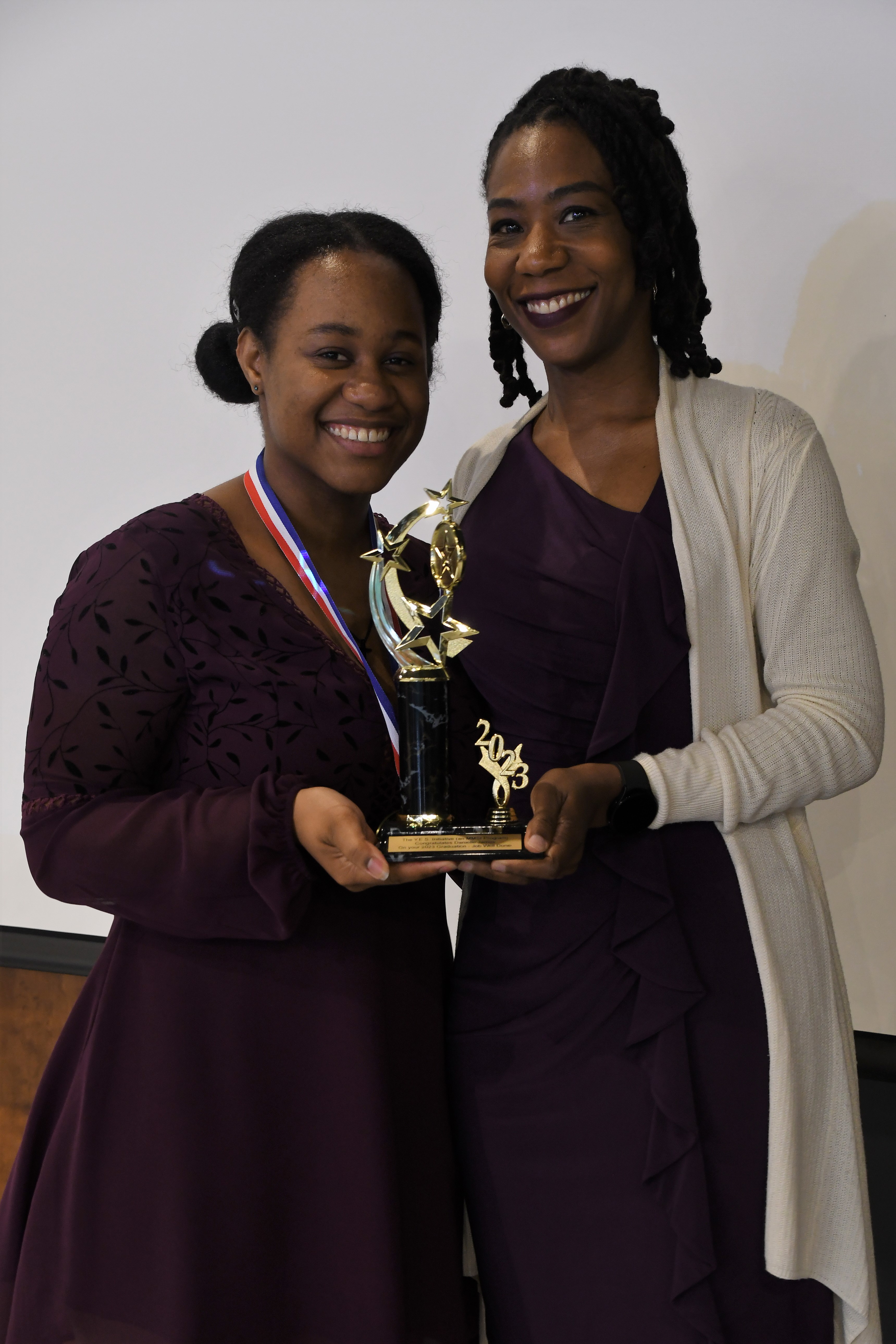 A student receives a trophy of special recognition.