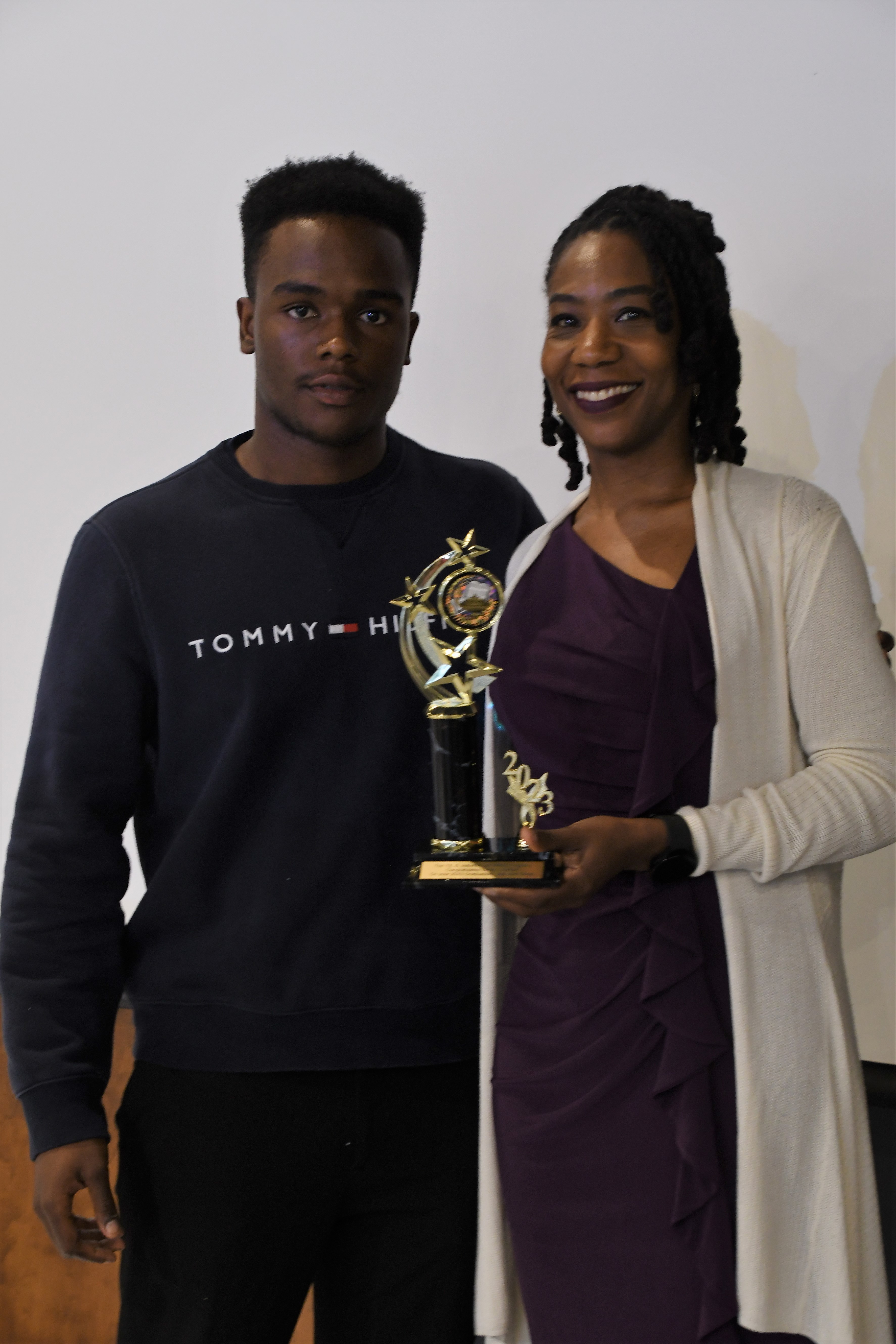 A student receives a trophy of special recognition.