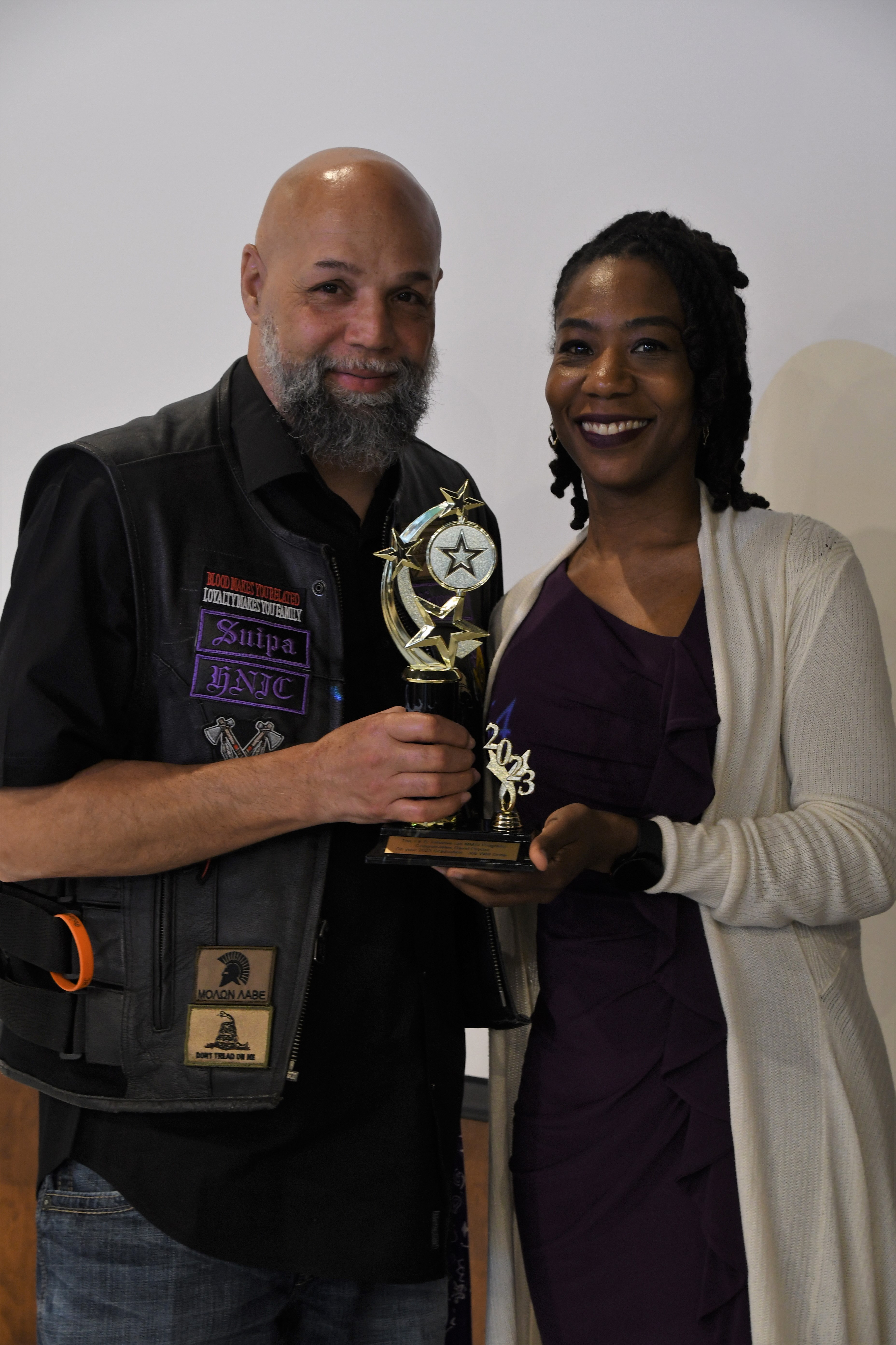 A student receives a trophy of special recognition.