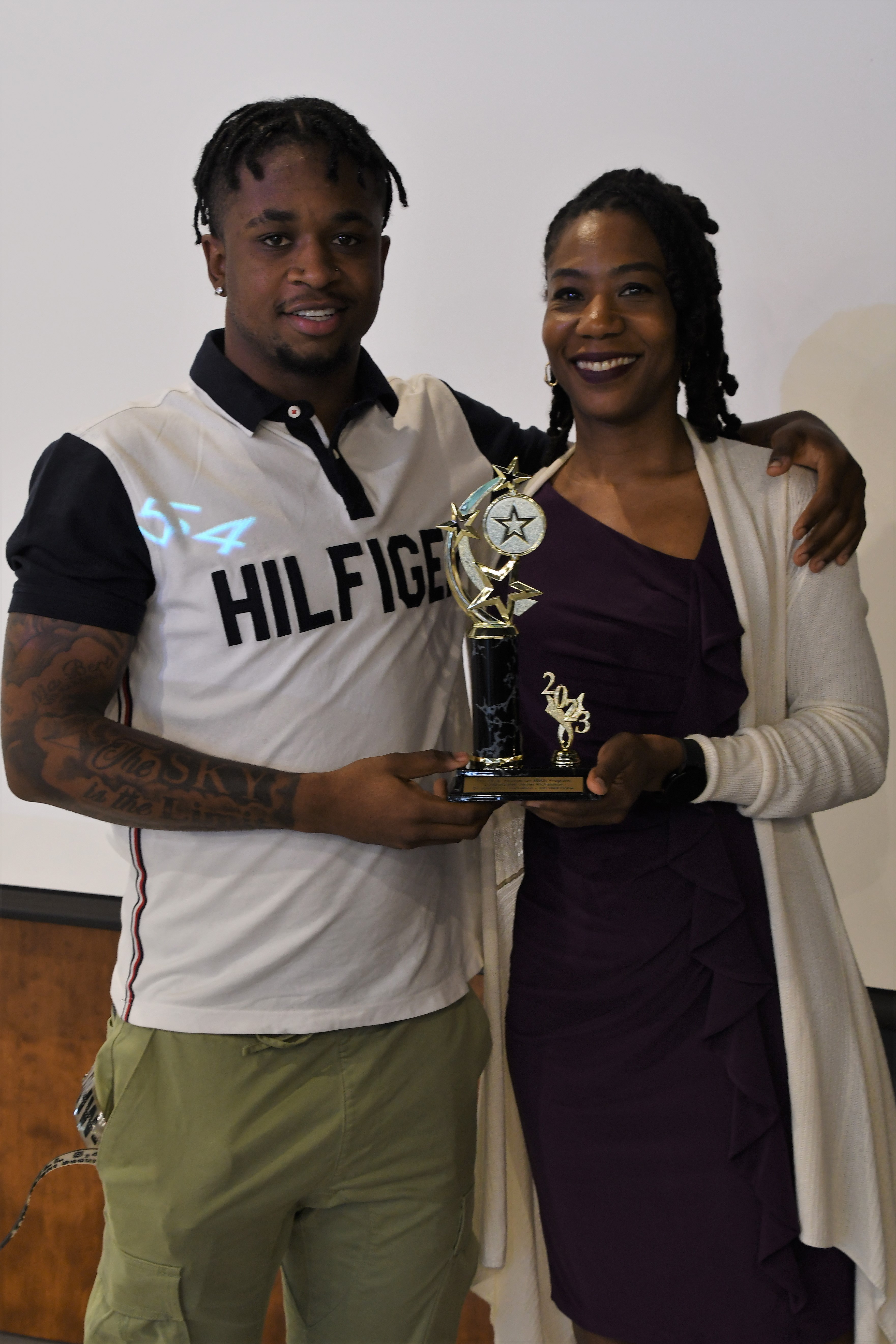 A student receives a trophy of special recognition.